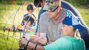 Cub Scout learning to safely participate in Archery